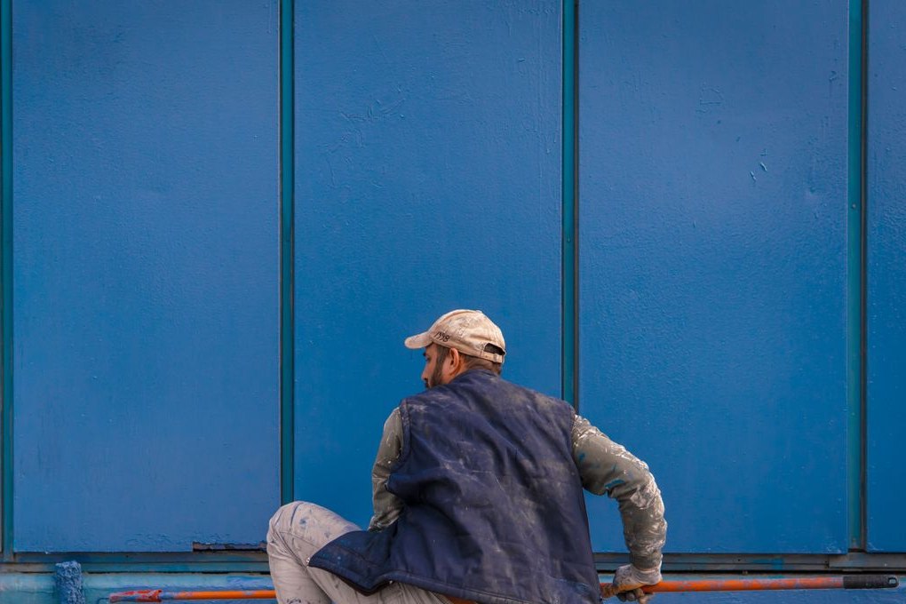 Exterior wall being freshly painted blue
