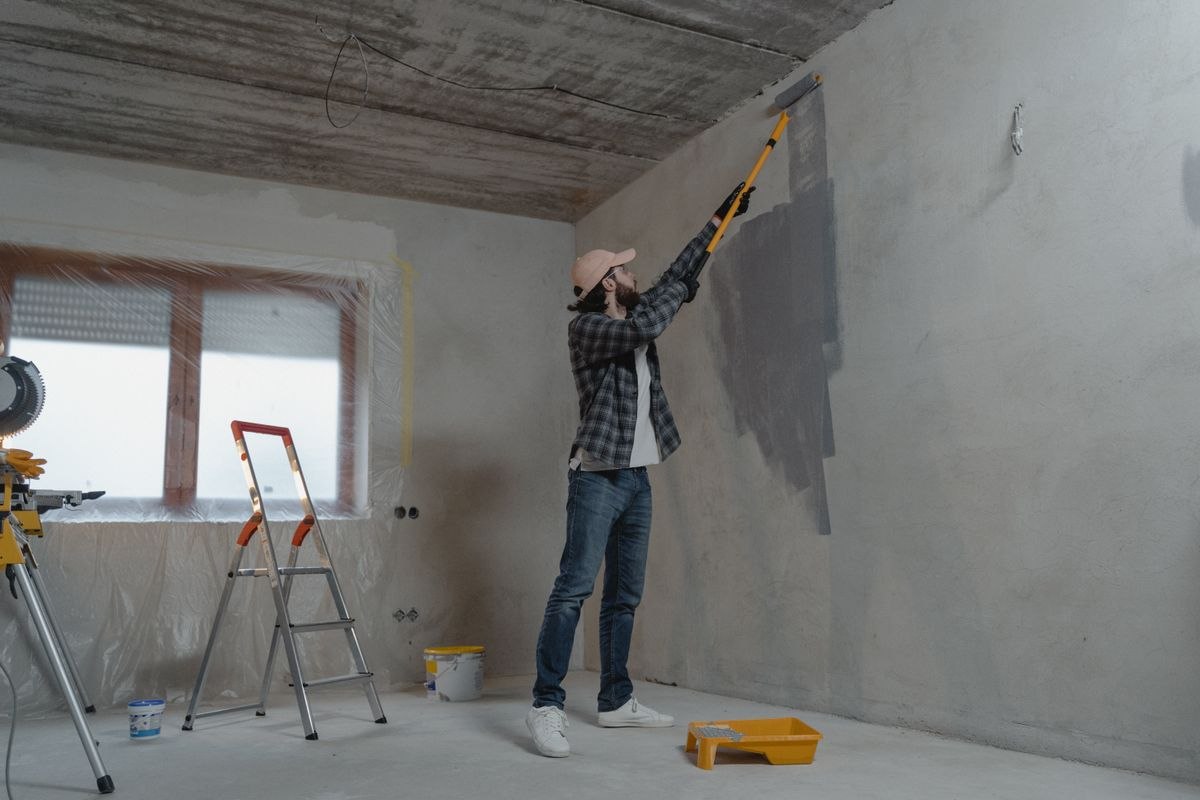 Exterior painting with a ladder and extension pole
