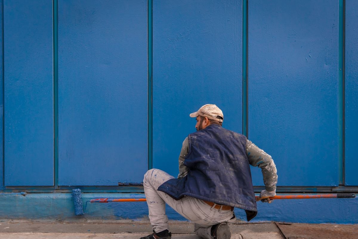 Painter rolling a fresh coat on an interior wall